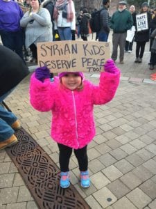 A Louisville child smiles as she demonstrates for Syrian children at Monday's Rally for American Values (photo by Beth Jacowitz Chottiner)
