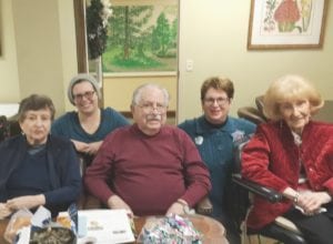 Friends of Shabbos Nira Riback (left), Lisa Sobel-Berlow, George Kaviar, Susan Sobel and Selma Rothstein during a December 15, 2016, program at Treyton Oak Towers. Sobel-Berlow and Sobel are among the Friends of Shabbos who volunteer their time at the building. (photo provided by Treyton Oaks Towers) 
